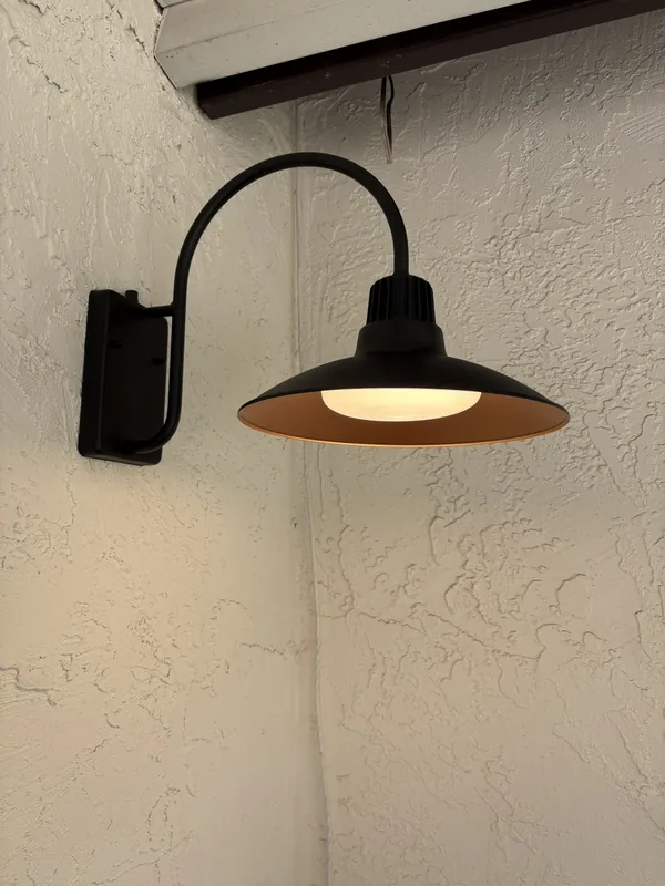Outdoor gooseneck barn light installed on stucco