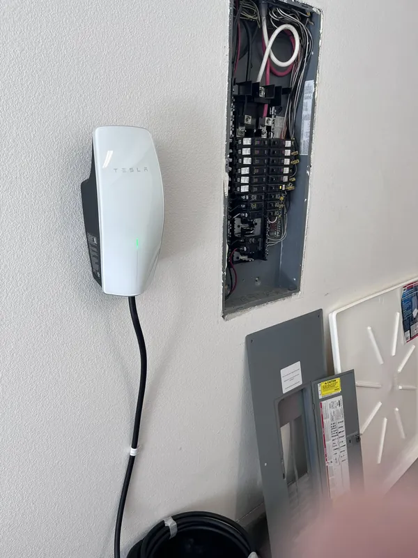 Tesla Wall Connector installed next to an upgraded electrical panel